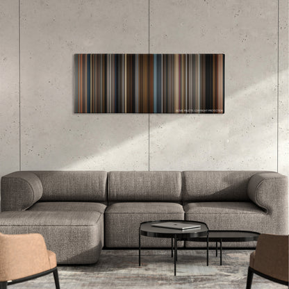 Prisoners color palette canvas on a concrete wall above a gray sectional sofa