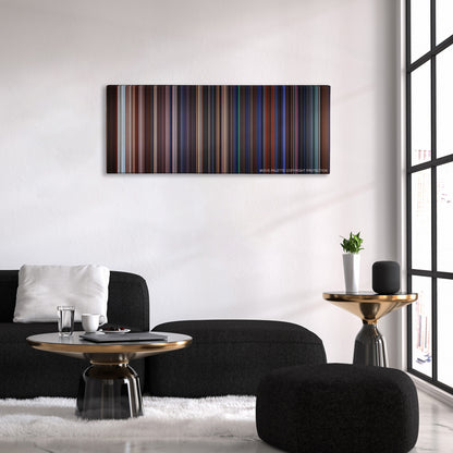 Gremlins color palette canvas above a black sofa with a gold-topped table