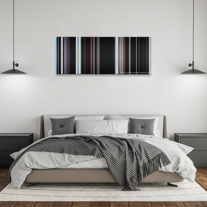 Under the Skin color palette canvas above a bed, between two black pendant lamps
