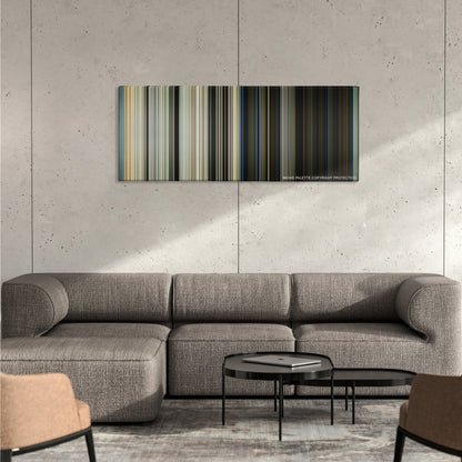 Captain Phillips color palette canvas on a concrete wall above a gray sectional sofa