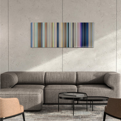 Your Name. color palette canvas on a concrete wall above a gray sectional sofa