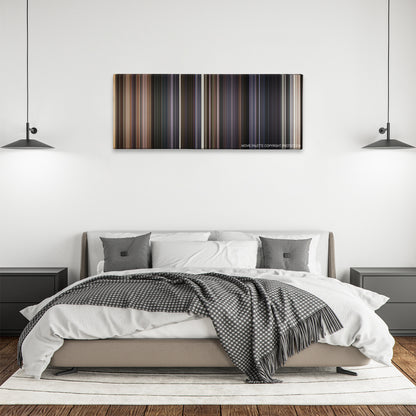The Lone Ranger color palette canvas above a bed, between two black pendant lamps