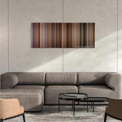 Jerry Maguire color palette canvas on a concrete wall above a gray sectional sofa