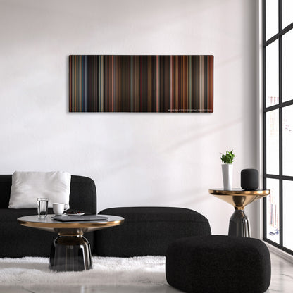 The Greatest Showman color palette canvas above a black sofa with a gold-topped table