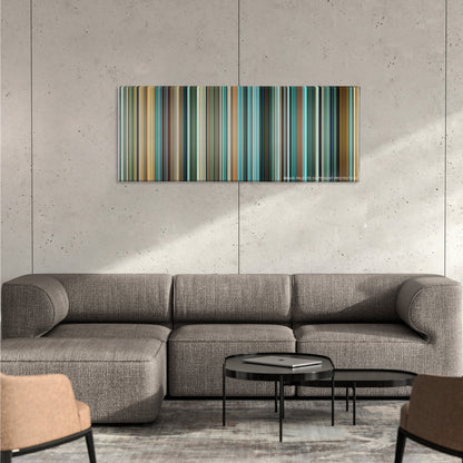 Layer Cake color palette canvas on a concrete wall above a gray sectional sofa