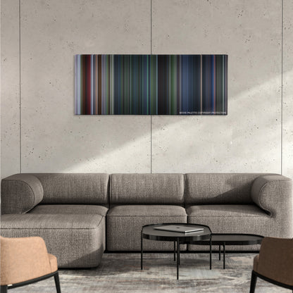 Jurassic Park III color palette canvas on a concrete wall above a gray sectional sofa