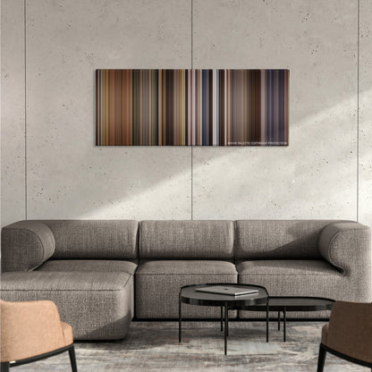 Willow color palette canvas on a concrete wall above a gray sectional sofa