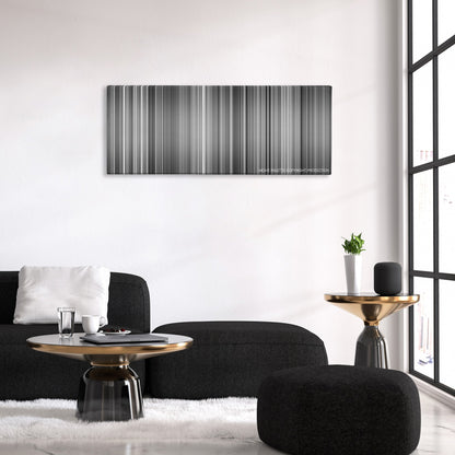 M color palette canvas above a black sofa with a gold-topped table