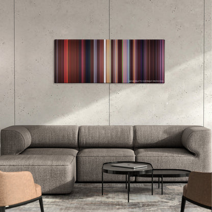 Antz color palette canvas on a concrete wall above a gray sectional sofa