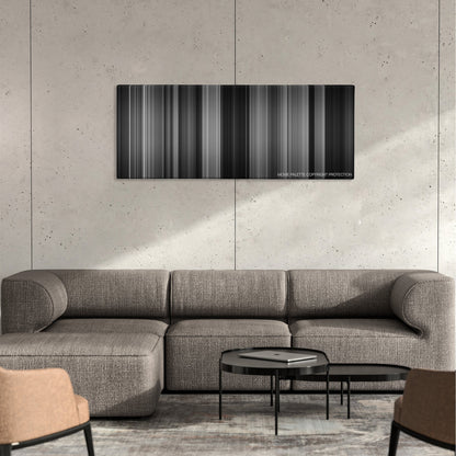 Double Indemnity color palette canvas on a concrete wall above a gray sectional sofa