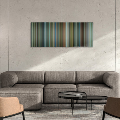 Man on Fire color palette canvas on a concrete wall above a gray sectional sofa