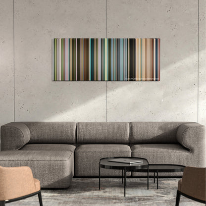 The Constant Gardener color palette canvas on a concrete wall above a gray sectional sofa