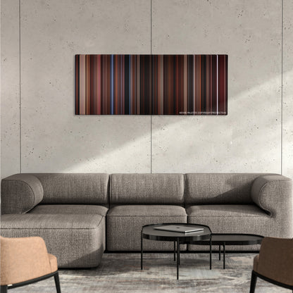 The Lost Boys color palette canvas on a concrete wall above a gray sectional sofa