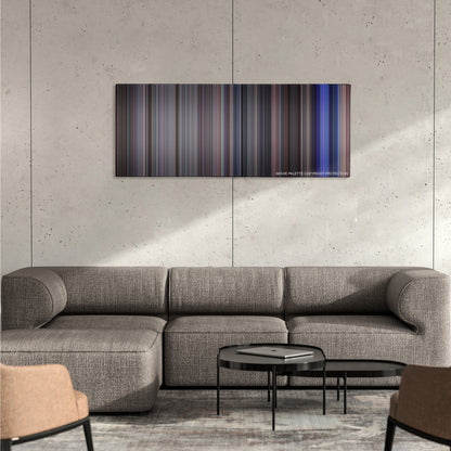 School of Rock color palette canvas on a concrete wall above a gray sectional sofa