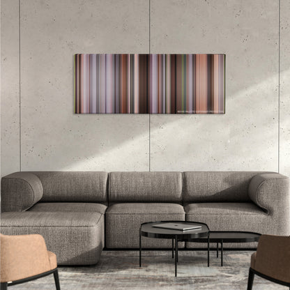 The Intern color palette canvas on a concrete wall above a gray sectional sofa