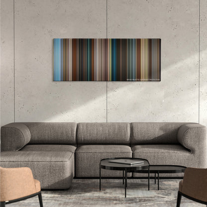 Tag color palette canvas on a concrete wall above a gray sectional sofa