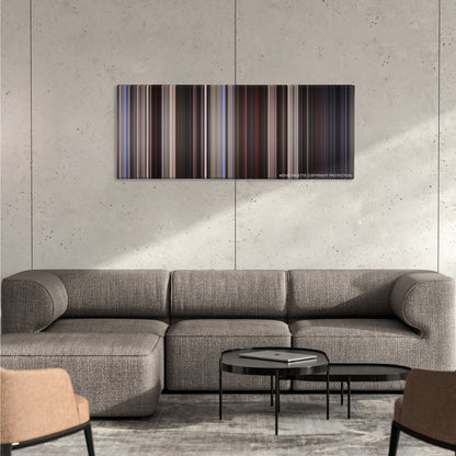 American Beauty color palette canvas on a concrete wall above a gray sectional sofa