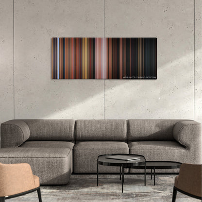 Stuart Little color palette canvas on a concrete wall above a gray sectional sofa