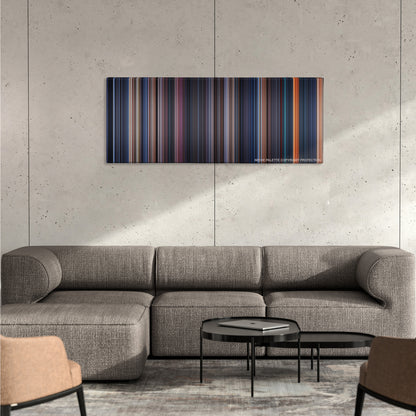 The Terminator color palette canvas on a concrete wall above a gray sectional sofa