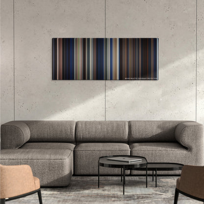 A Nightmare on Elm Street color palette canvas on a concrete wall above a gray sectional sofa
