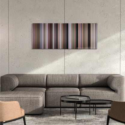 Dr. No color palette canvas on a concrete wall above a gray sectional sofa