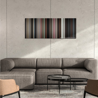 Lethal Weapon color palette canvas on a concrete wall above a gray sectional sofa