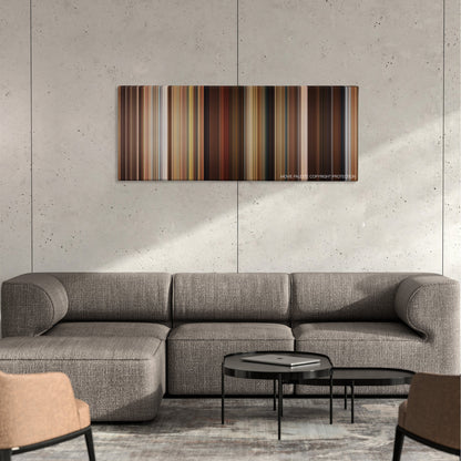 Identity Thief color palette canvas on a concrete wall above a gray sectional sofa
