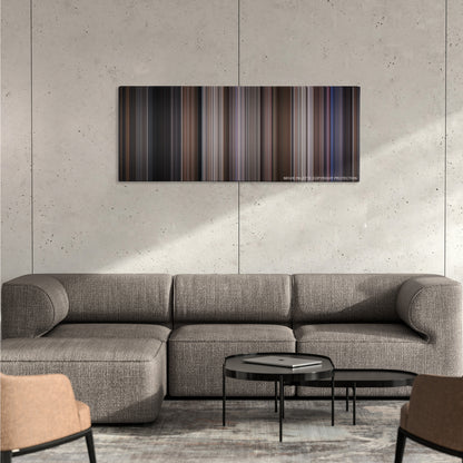 Ronin color palette canvas on a concrete wall above a gray sectional sofa