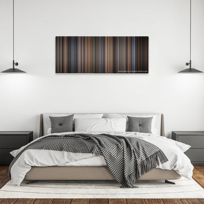 The Hours color palette canvas above a bed, between two black pendant lamps