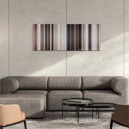 Rambo III color palette canvas on a concrete wall above a gray sectional sofa