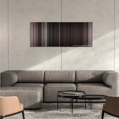 The Goonies color palette canvas on a concrete wall above a gray sectional sofa