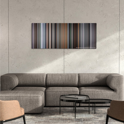 The Italian Job color palette canvas on a concrete wall above a gray sectional sofa