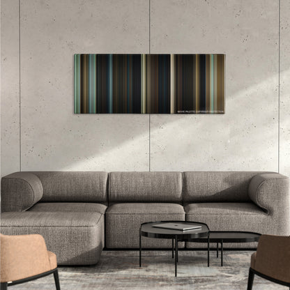 Les Miserables color palette canvas on a concrete wall above a gray sectional sofa
