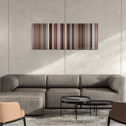 The Firm color palette canvas on a concrete wall above a gray sectional sofa