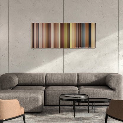 Just Go with It color palette canvas on a concrete wall above a gray sectional sofa