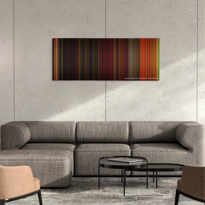 Irreversible color palette canvas on a concrete wall above a gray sectional sofa