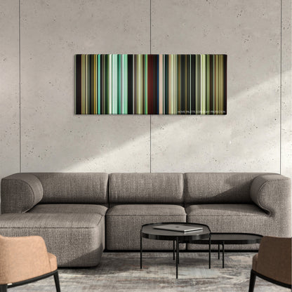 Bronson color palette canvas on a concrete wall above a gray sectional sofa