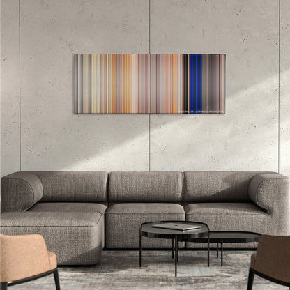 Clerks II color palette canvas on a concrete wall above a gray sectional sofa