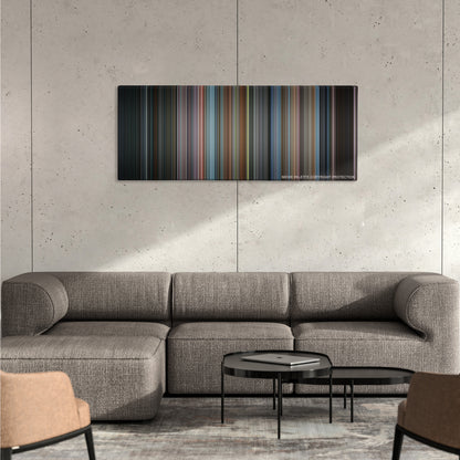 Men in Black color palette canvas on a concrete wall above a gray sectional sofa