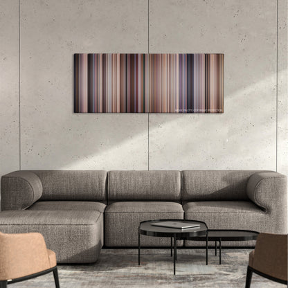 Evolution color palette canvas on a concrete wall above a gray sectional sofa