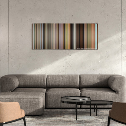The Descendants color palette canvas on a concrete wall above a gray sectional sofa
