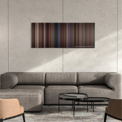 Ransom color palette canvas on a concrete wall above a gray sectional sofa