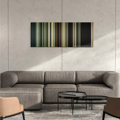 It color palette canvas on a concrete wall above a gray sectional sofa