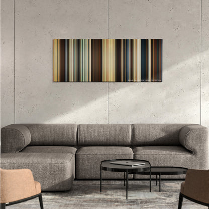 Troy color palette canvas on a concrete wall above a gray sectional sofa