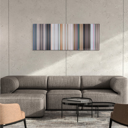 Superman II color palette canvas on a concrete wall above a gray sectional sofa