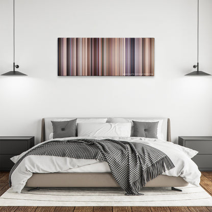 Evolution color palette canvas above a bed, between two black pendant lamps