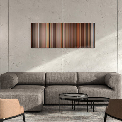 Amadeus color palette canvas on a concrete wall above a gray sectional sofa