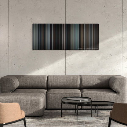 Heat color palette canvas on a concrete wall above a gray sectional sofa