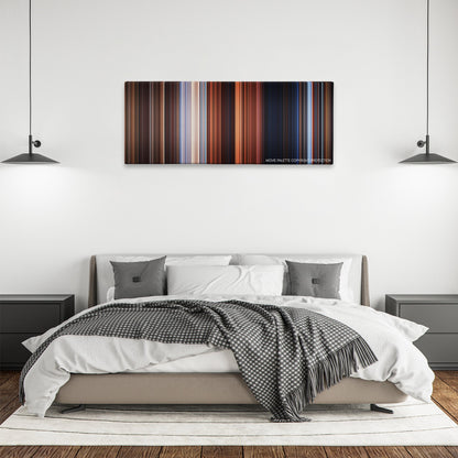 The Time Machine color palette canvas above a bed, between two black pendant lamps