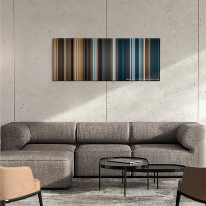 The Golden Compass color palette canvas on a concrete wall above a gray sectional sofa